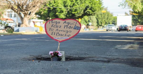 Colocan flores y carteles en baches de San Pedro Cholula